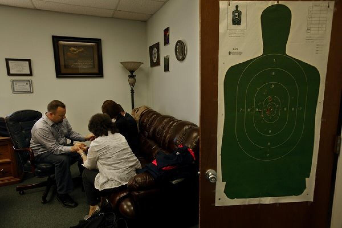 McAbee's church office holds reminders of his side job as a shooting instructor.