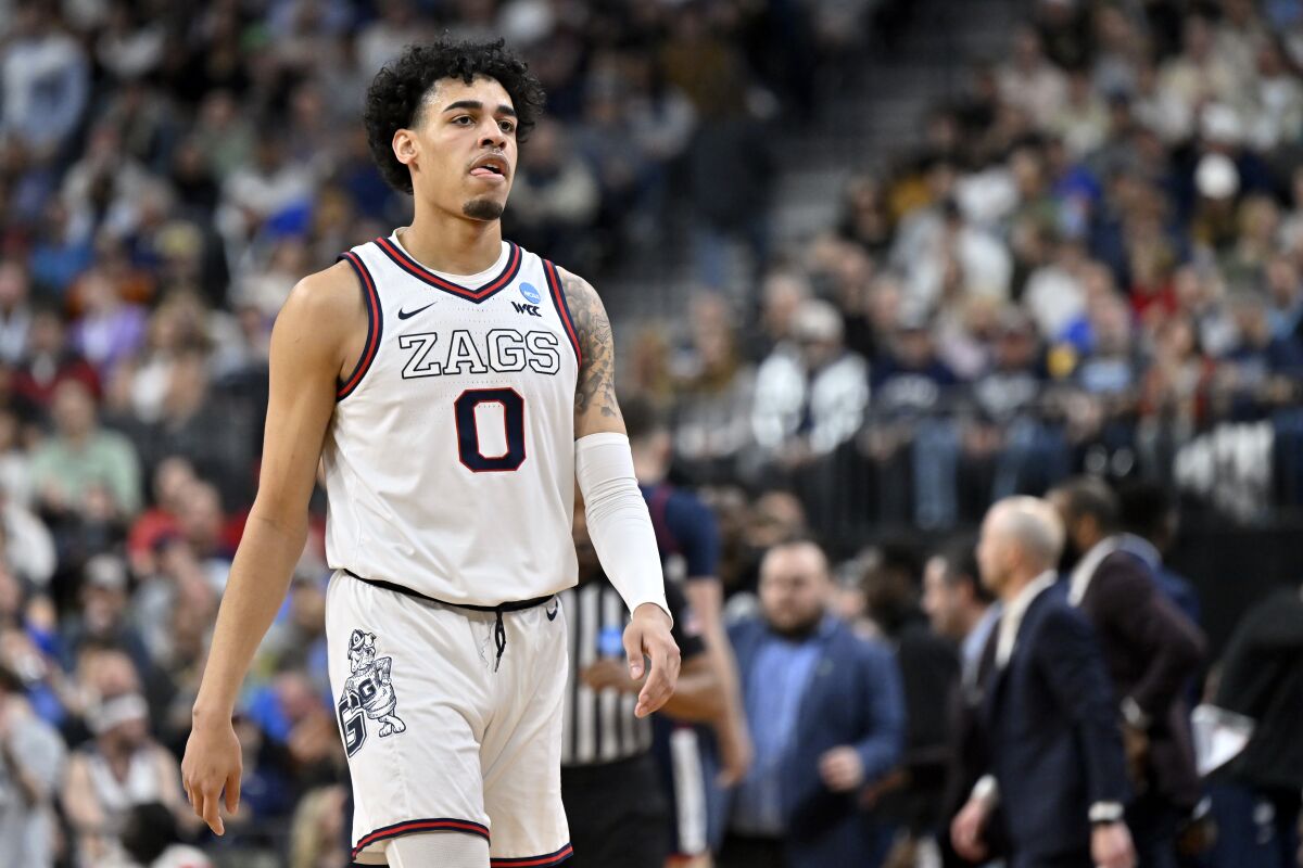 Gonzaga guard Julian Strawther (0) reacts while talking towards the bench in the first half of an Elite 8 college basketball game against UConn in the West Region final of the NCAA Tournament, Saturday, March 25, 2023, in Las Vegas. (AP Photo/David Becker)