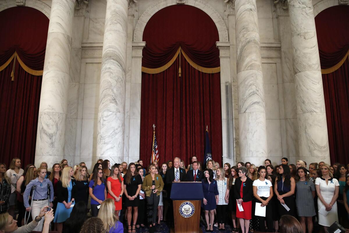 U.S. senators at a news conference with dozens of women and girls who were sexually abused by Larry Nassar.