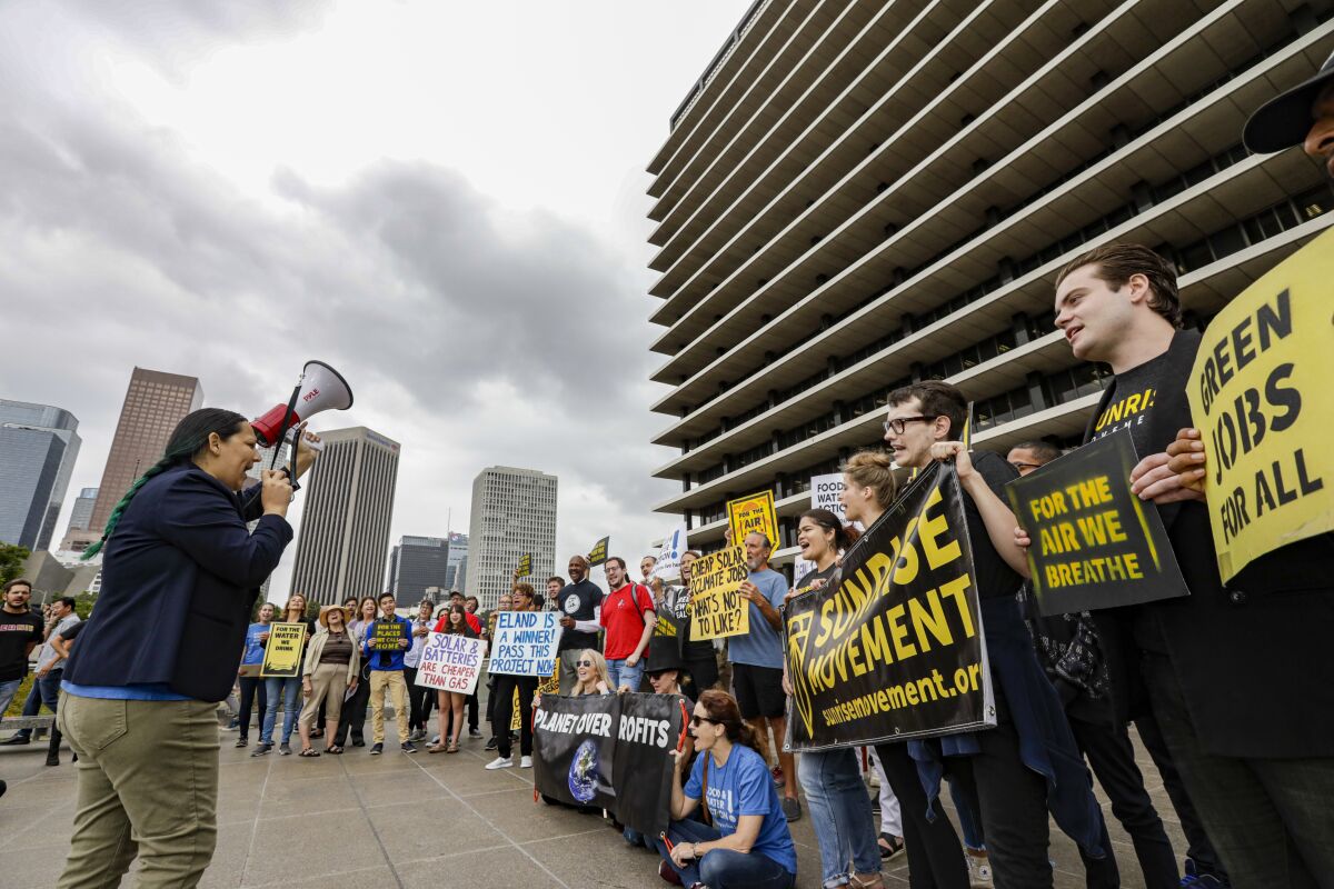 Environmental activists rally in support of the Eland solar contract outside the Los Angeles Department of Water and Power's headquarters Tuesday. The board went on to unanimously approve the 25-year contract.