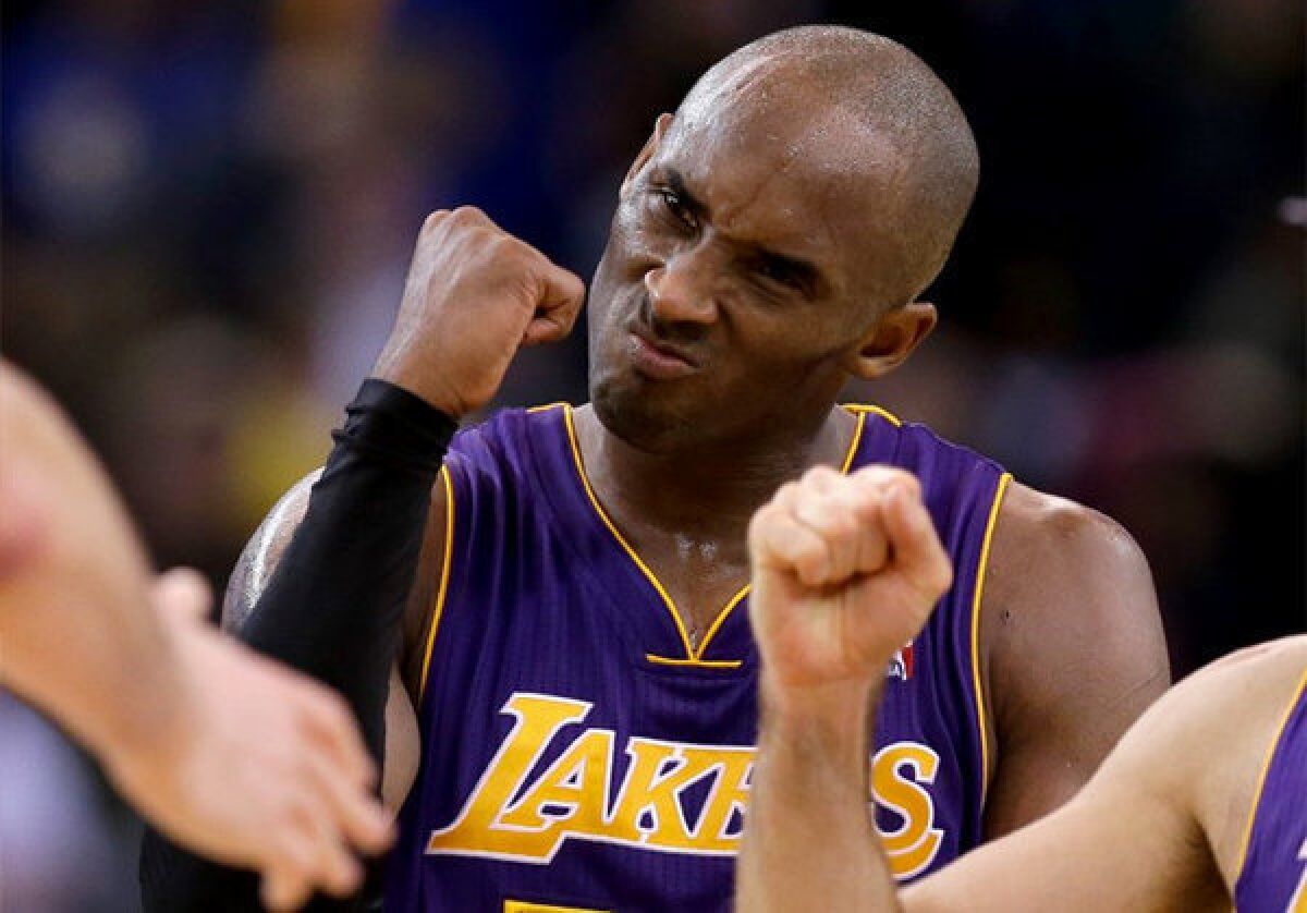 Kobe Bryant celebrates after the Lakers beat the Warriors in overtime.