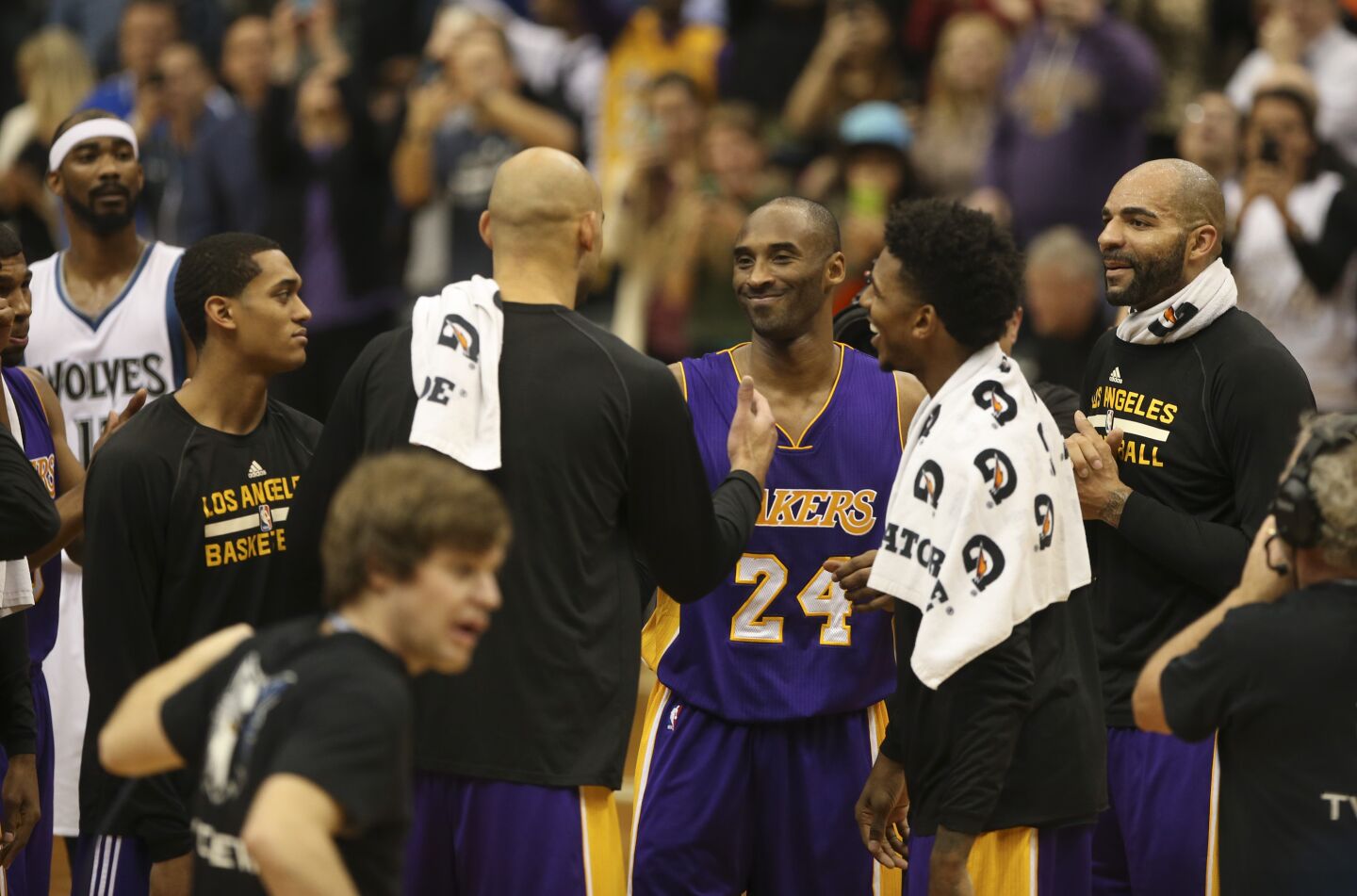 Teammates congratulate Kobe Bryant after he passed Michael Jordan's career points total in 2014.
