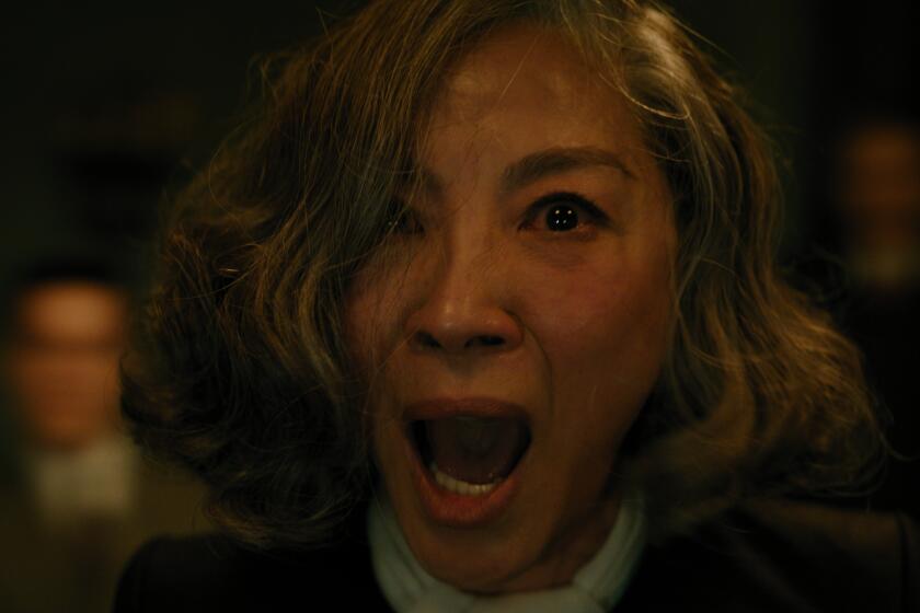 A close-up of Michelle Yeoh screaming