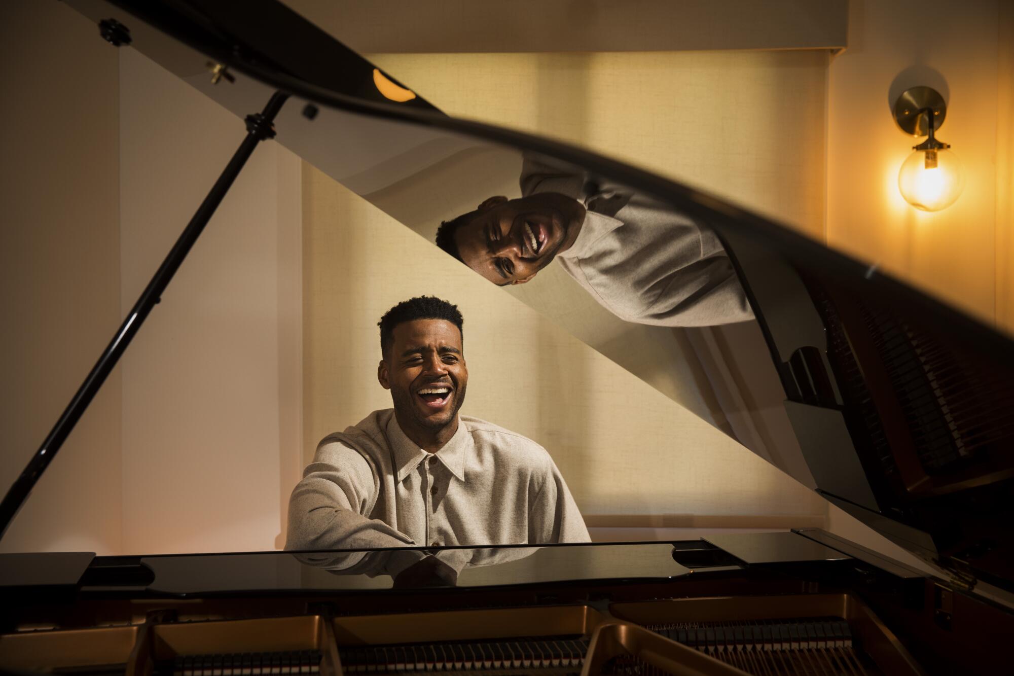 A man laughs at a piano 