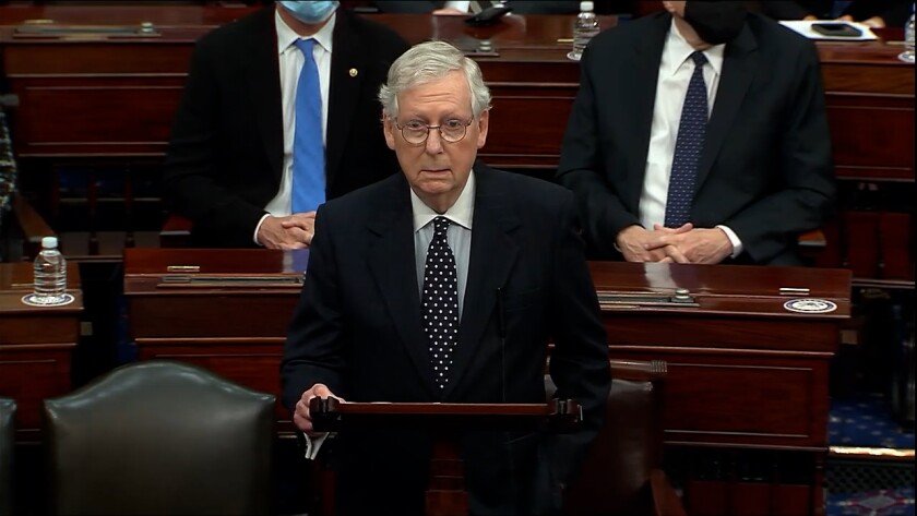 Mitch McConnell stands at a podium.