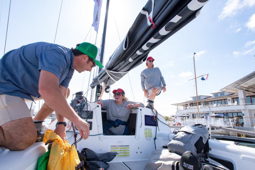 Spencer Buchanan, from left, boat owner Brett Scott and Adam Bradley rig the Blitzen.