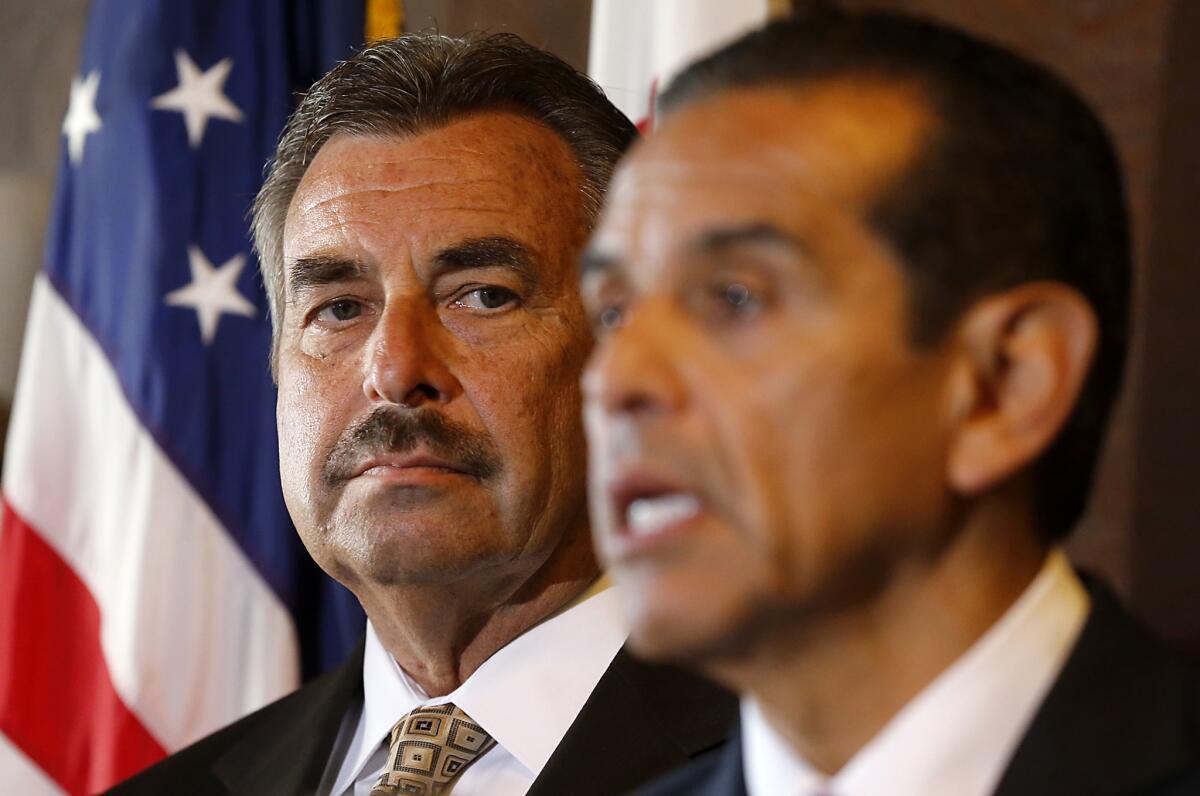 In 2013, Los Angeles police Chief Charlie Beck, left, and then-Mayor Antonio Villaraigosa announce the end of federal oversight imposed following the Rampart police misconduct scandal.