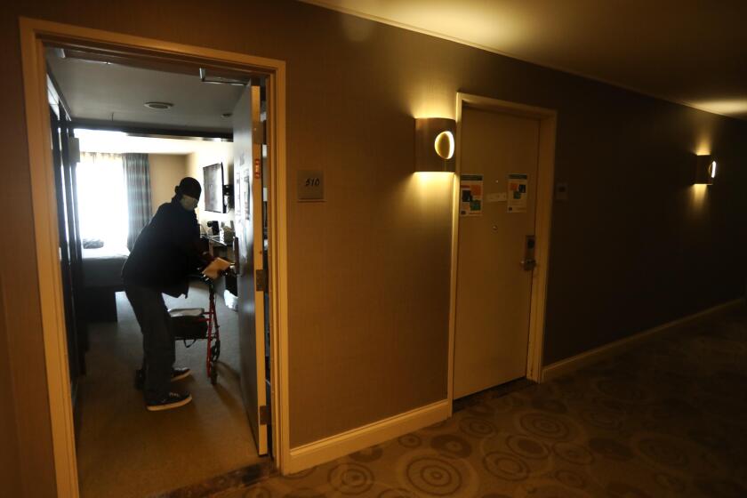 LOS ANGELES, CA - JULY 21, 2020 - - Project Roomkey guest David William, 63 returns to his room at a Project Roomkey hotel in Los Angeles on July 22, 2020. (Genaro Molina / Los Angeles Times)