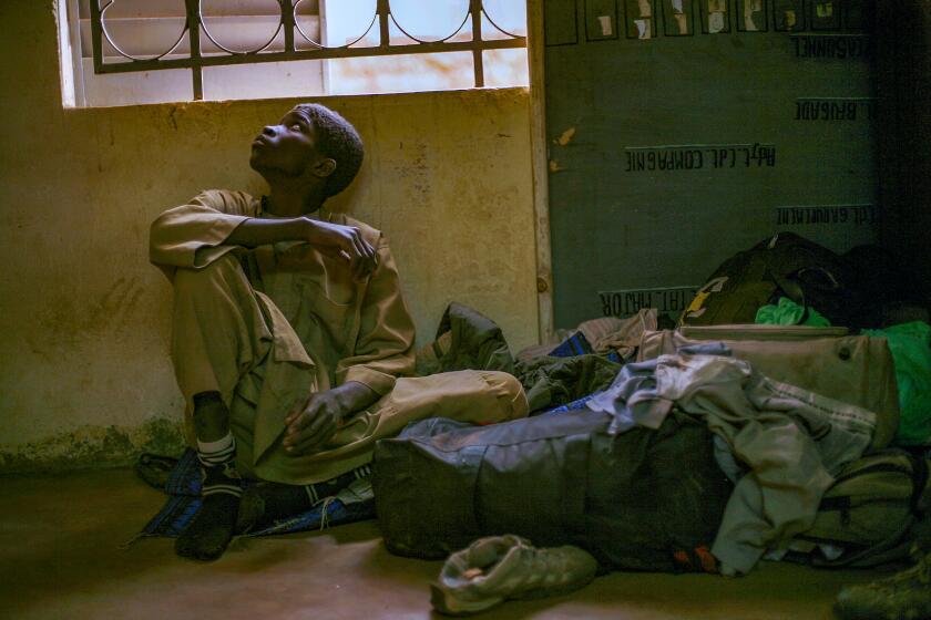 FILE - Adama Drabo, 16, who was arrested on suspicion of working for Islamic militant group MUJAO, sits in the police station in Sevare, some 620 kilometers (385 miles) north of Mali's capital Bamako Friday, Jan. 25, 2013. Trapped in conflict in a volatile region, children in West and Central Africa have become the most recruited by armed groups with the highest number of victims of sexual violence in the world, said a new report Tuesday Nov. 23, 2021 by the United Nations Children's Fund. (AP Photo/Jerome Delay, File)