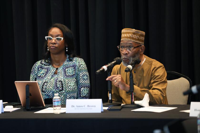 Kamilah Moore is chair of the California Reparations Task Force, left, and Dr. Amos C. Brown right, vice-chair.