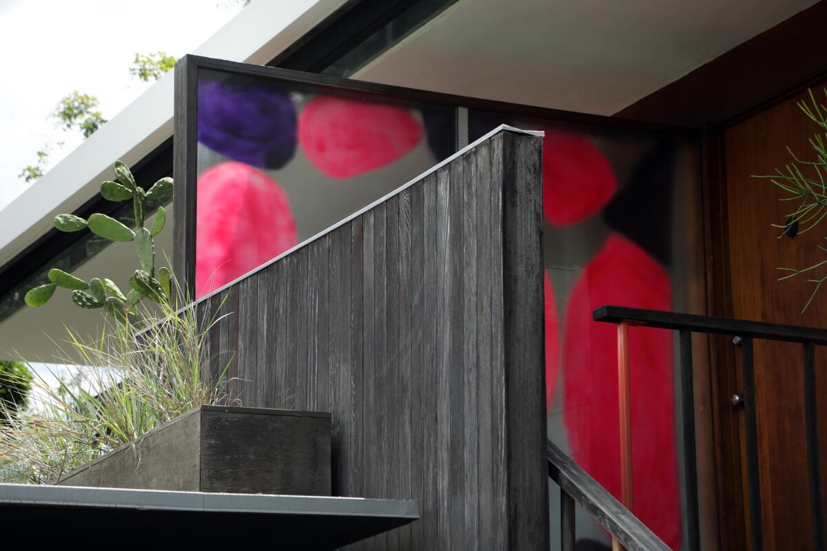 Adam Francis Scott and Julie Whaley's translucent painting "Corita, Constance, Richard, and Sharon (A Rose Is a Rose Is a Rose Is a Rose)" greets visitors to a 1955 Richard Neutra-designed house.