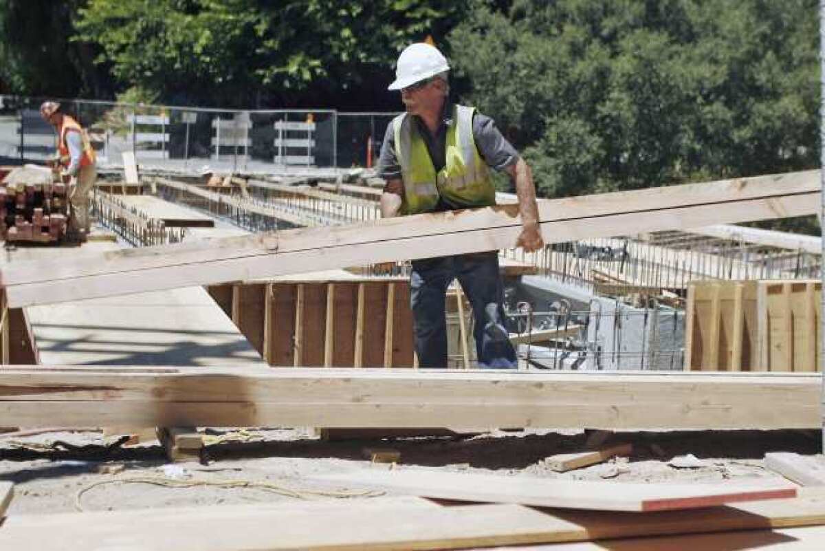 Construction workers reconstruct a bridge on Jessen Drive.