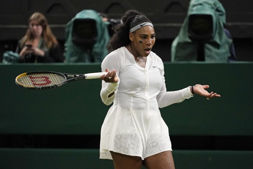 Serena Williams of the US reacts after losing a point as she plays France's Harmony Tan in a first round women's singles match on day two of the Wimbledon tennis championships in London, Tuesday, June 28, 2022. (AP Photo/Alberto Pezzali)