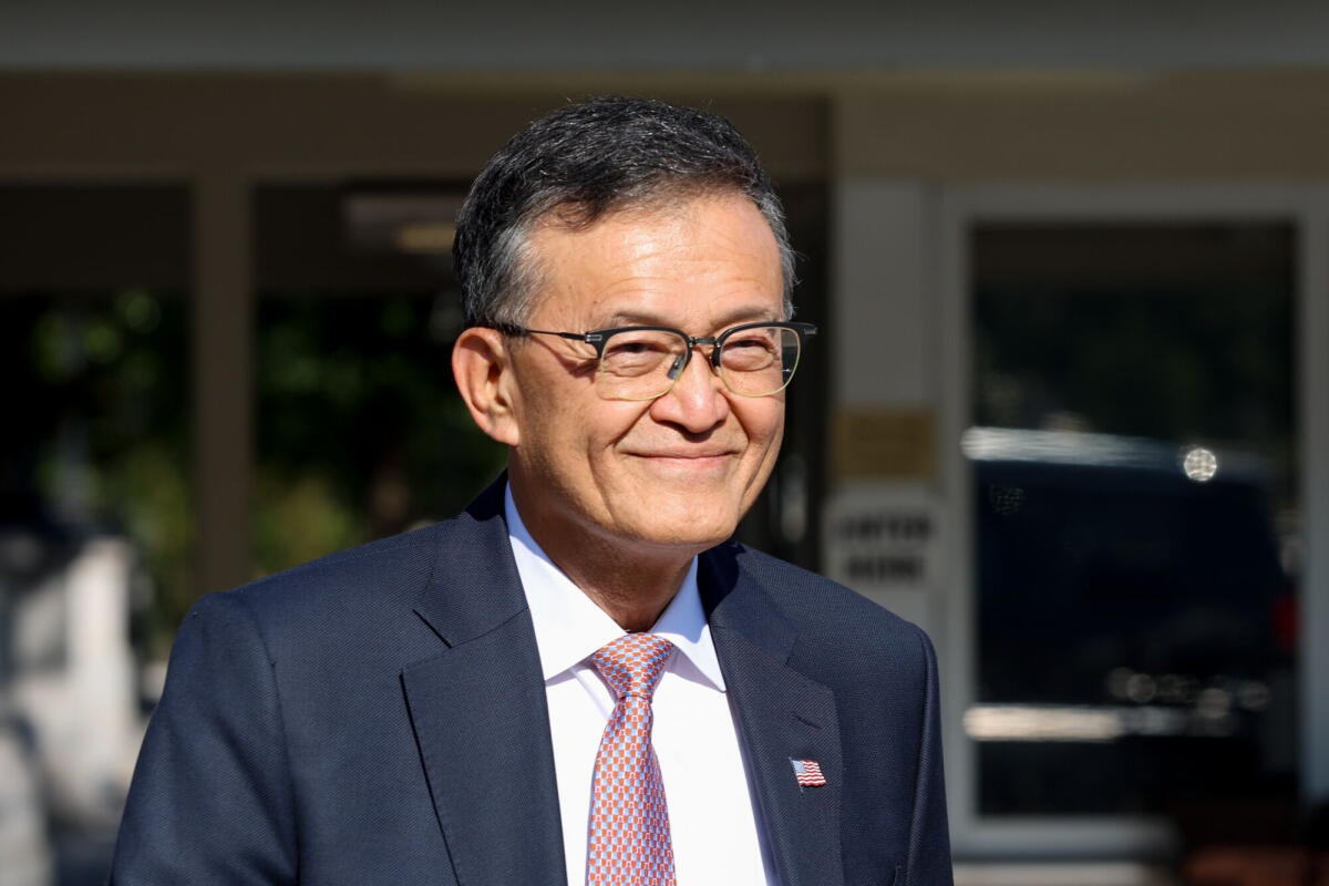 Lip-Bu Tan smiles in a business suit