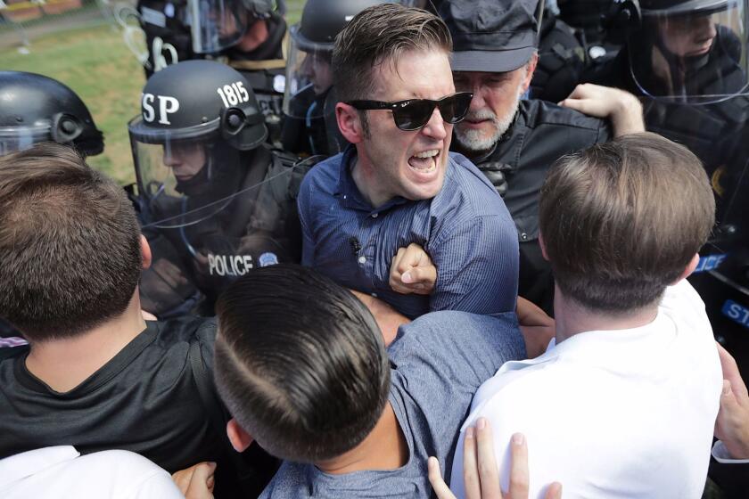 CHARLOTTESVILLE, VA - AUGUST 12: White nationalist Richard Spencer (C) and his supporters clash with Virginia State Police in Lee Park after the "Unite the Right" rally was declared an unlawful gathering August 12, 2017 in Charlottesville, Virginia. Hundreds of white nationalists, neo-Nazis and members of the "alt-right" clashed with anti-fascist protesters and police as they attempted to hold a rally in Lee Park, where a statue of Confederate General Robert E. Lee is slated to be removed. (Photo by Chip Somodevilla/Getty Images) *** BESTPIX *** ** OUTS - ELSENT, FPG, CM - OUTS * NM, PH, VA if sourced by CT, LA or MoD **