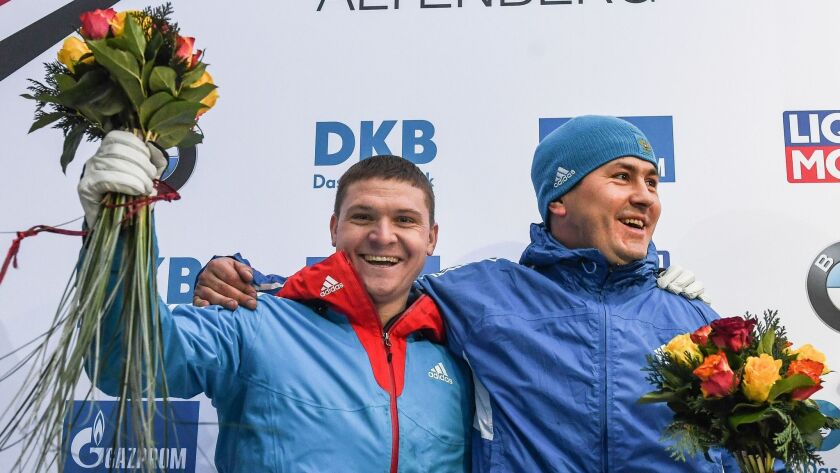Russia's Aleksandr Kas’yanov, left, and Aleksei Pushkarev, shown at the Bobsleigh World Cup in Germany on Jan. 7, were found to have violated anti-doping rules at the Sochi Olympics, the International Olympic Committee said.