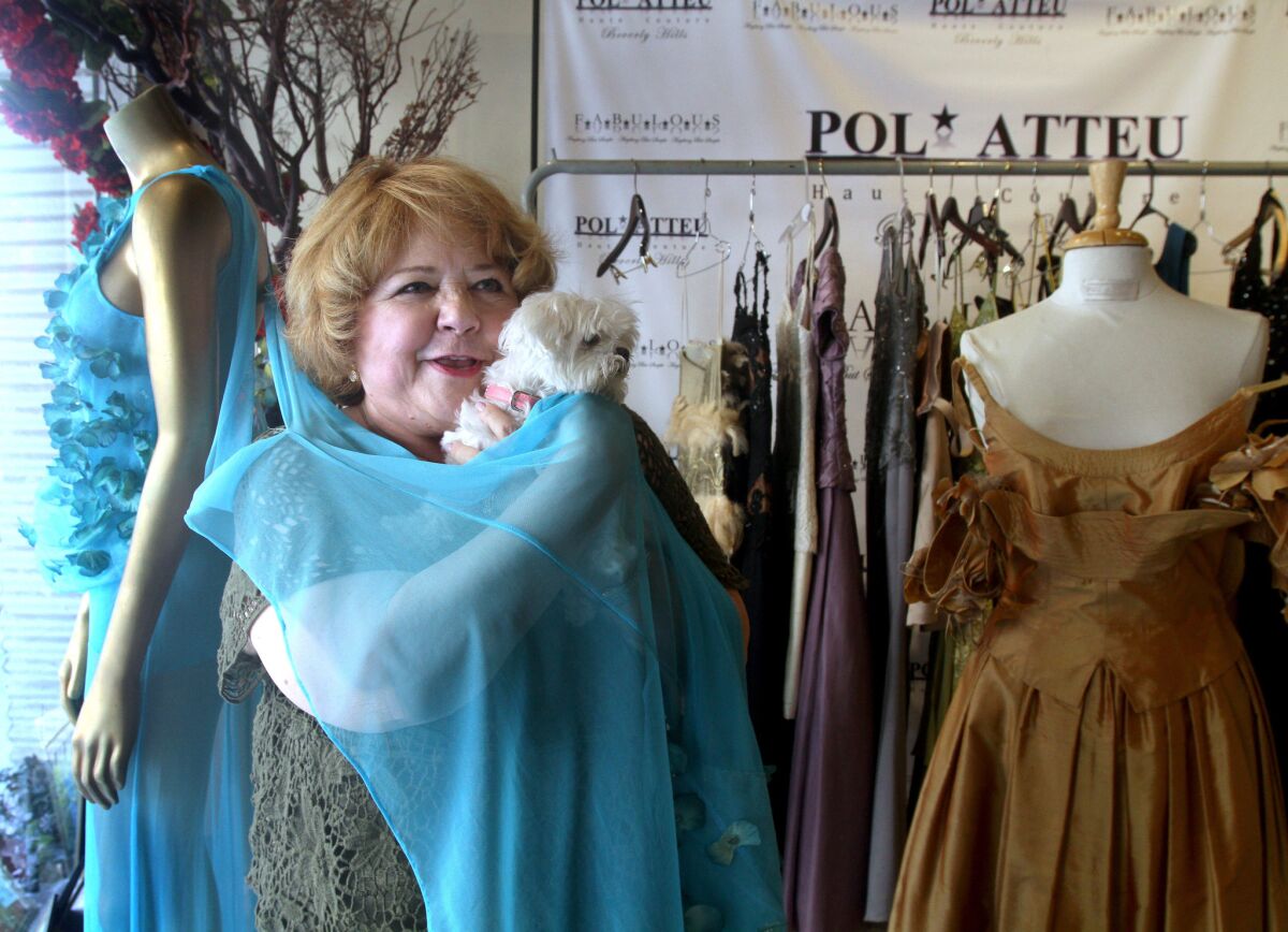 Emmy-nominated actress Patrika Darbo, with her dog SnowWhite, tries on a dress at Pol Atteu, Haute Couture, in Beverly Hills on Tuesday, Aug. 9, 2016.