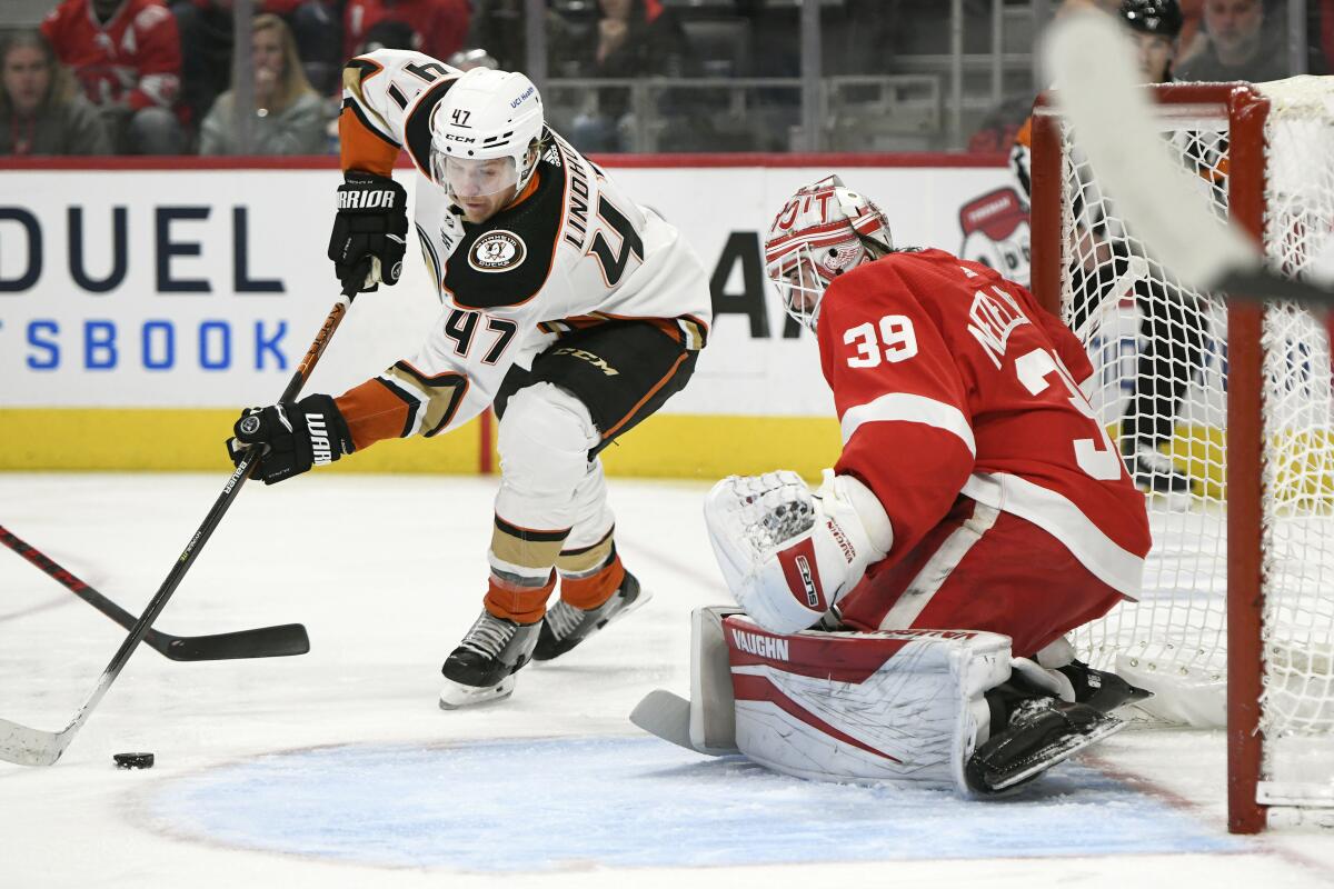 Ducks defenseman Hampus Lindholm tries to score but is blocked by Detroit Red Wings goaltender Alex Nedeljkovic.