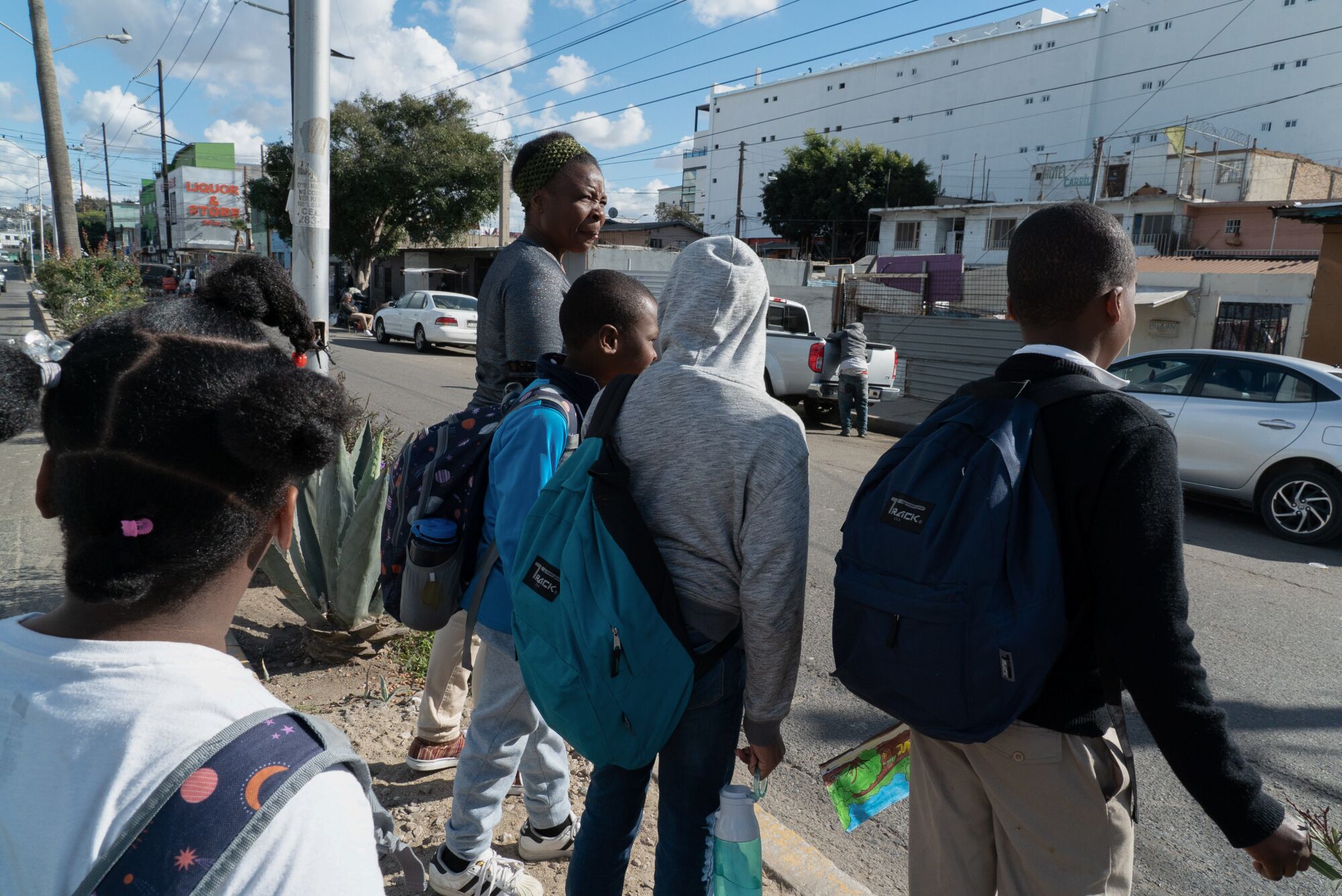 Antoinette Darelus, walks her children and two neighbors to school in downtown Tijuana.