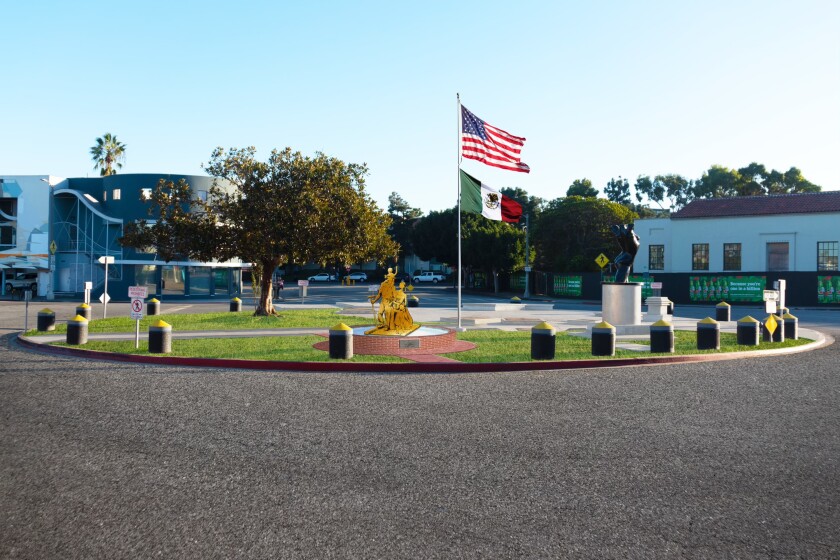 A rendering of a bronze monument in the middle of a traffic circle with U.S. and Mexican flags