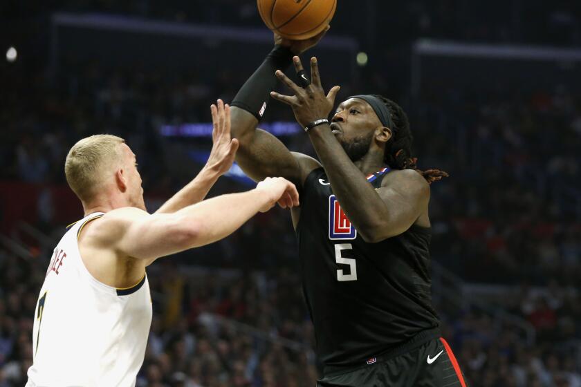 LOS ANGELES, CALIF. -- FRIDAY, FEBRUARY 28, 2020: LA Clippers forward Montrezl Harrell (5) takes a shot guarded by Denver Nuggets forward Mason Plumlee (7) in the second half at the Staples Center in Los Angeles, Calif., on Feb. 28, 2020. Clippers won 132-103. (Gary Coronado / Los Angeles Times)