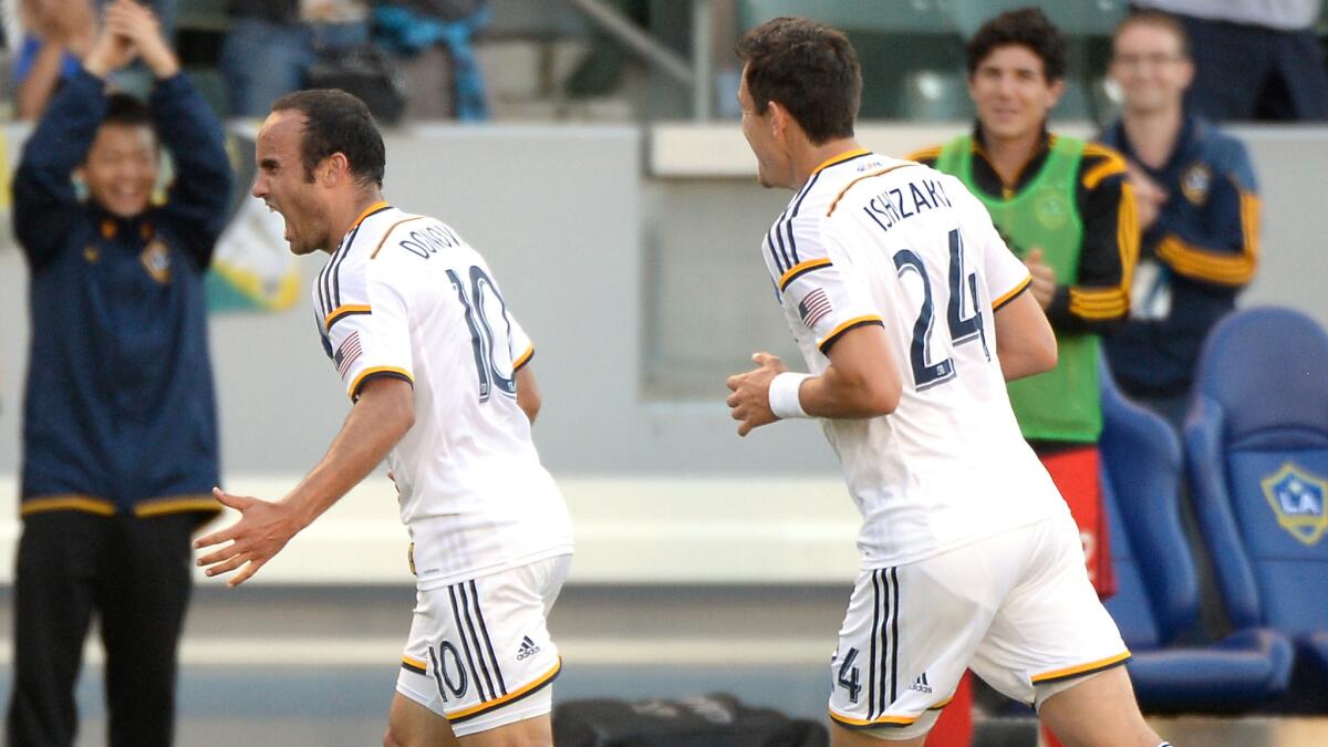 Galaxy forward Landon Donovan, left, celebrates along with teammate Stefan Ishizaki after scoring his second goal of the game in a 4-0 win over the Philadelphia Union on Sunday.