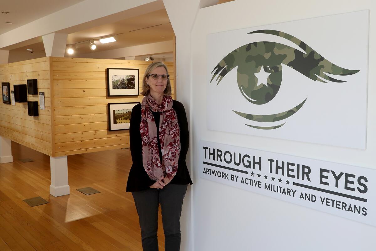 Heroes Hall Supervisor Carol Singleton at "Through Their Eyes: Artwork by Active Military and Veterans," opening Wednesday.