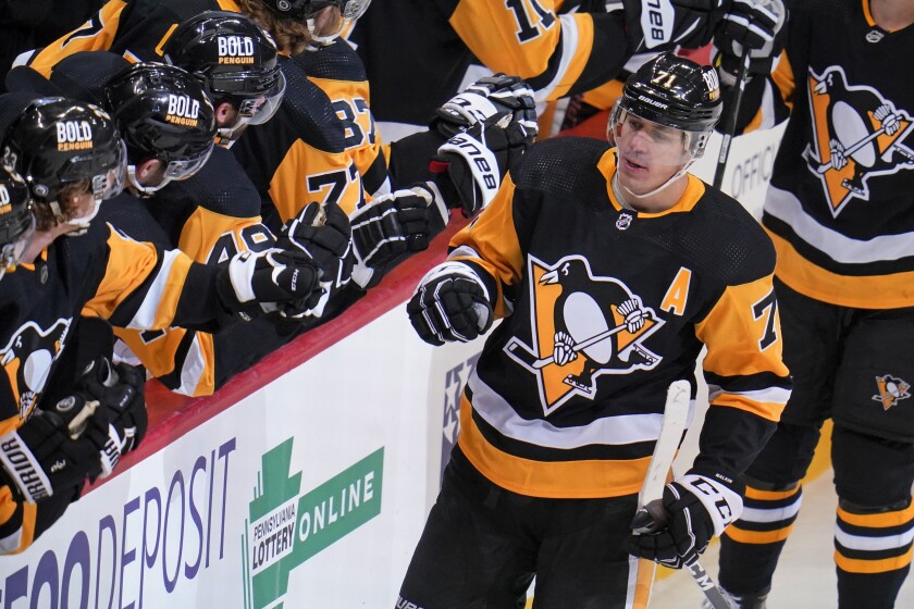 Pittsburgh Penguins' Evgeni Malkin (71) celebrates as he returns to the bench after scoring during the first period of the team's NHL hockey game against the Ottawa Senators in Pittsburgh, Thursday, Jan. 20, 2022. (AP Photo/Gene J. Puskar)