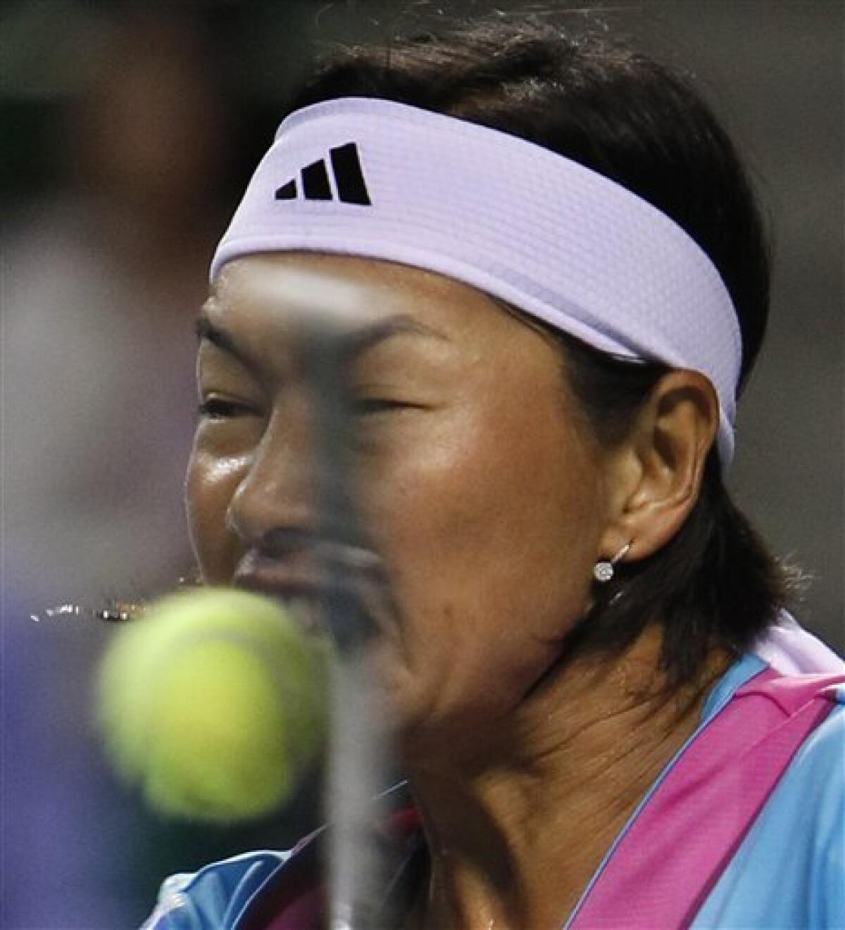 Kimiko Date-Krumm of Japan returns a ball to Mandy Minella of Luxembourg during the first round match of the Japan Pan Pacific Open tennis tournament in Tokyo, Monday, Sept. 26, 2011. Minella won 1-6, 6-3, 6-3. (AP Photo/Shizuo Kambayashi)
