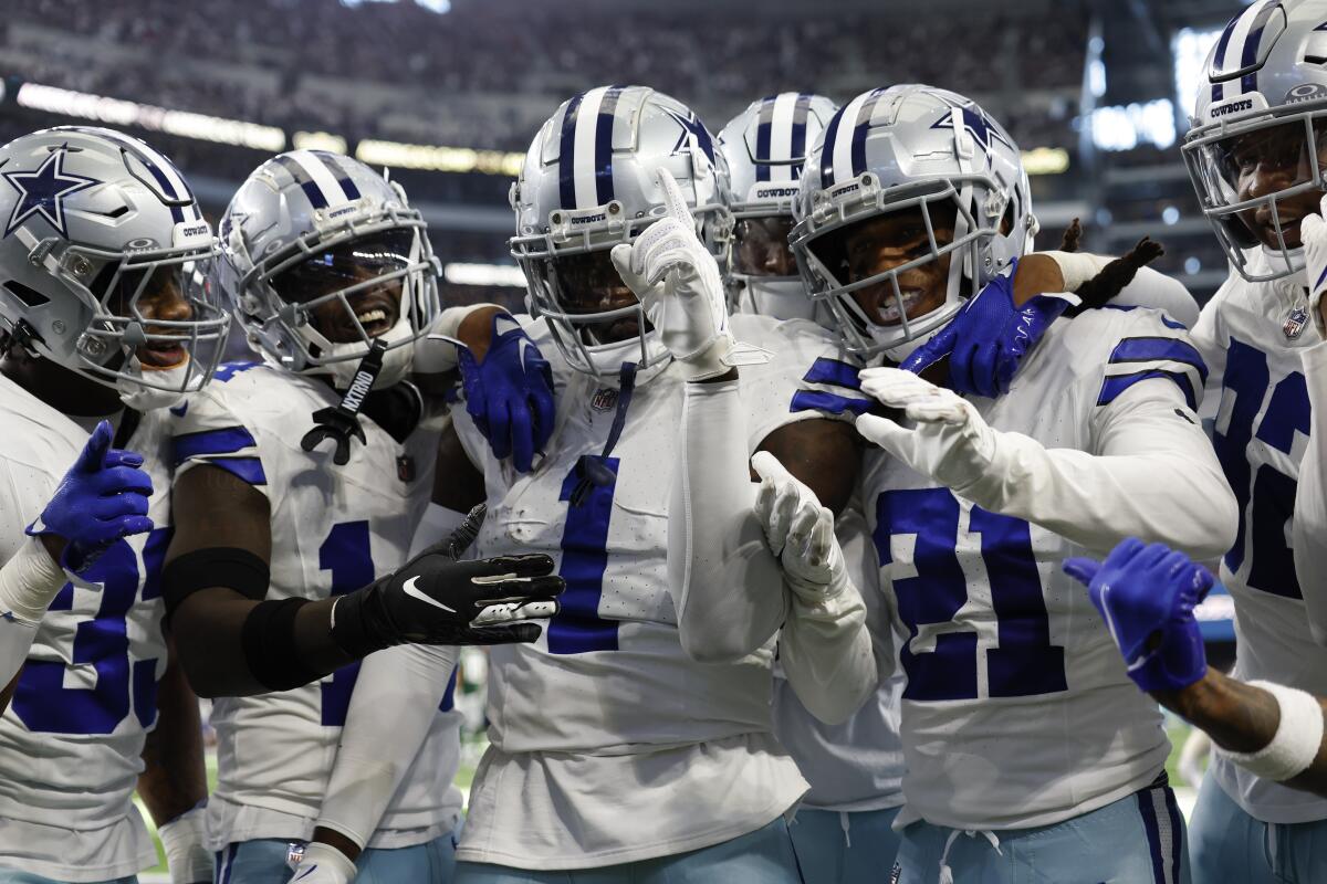 Dallas Cowboys defensive back Jayron Kearse along with other defensive teammates celebrate after an interception.