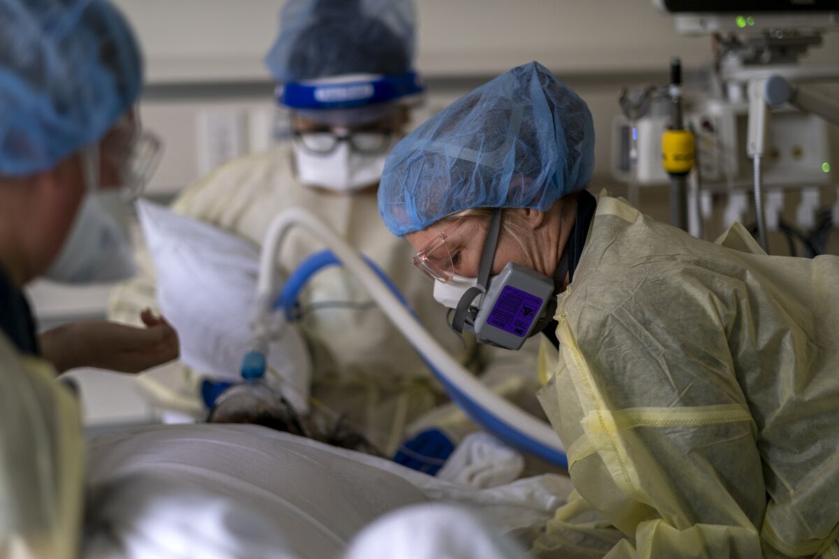 A respiratory therapist works with a COVID-19 patient at Ventura County Medical Center.