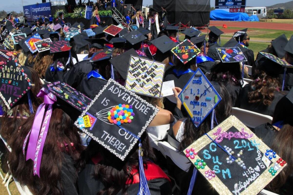 Students' decorated mortar boards at a California State University San Marcos graduation