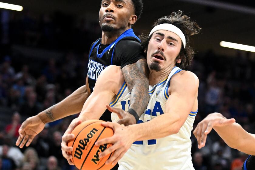Sacramento California March 16, 2023-UCLA's Jaime Jaquez Jr. battles for a rebound with UNC Asheville's Jamon Battle in the first half of the first round of the NCAA Tournament in Sacramento Thursday. (Wally Skalij/Los Angeles Times)