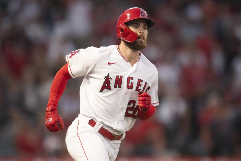 Los Angeles Angels' Jared Walsh watches his two-run home run during a baseball game.