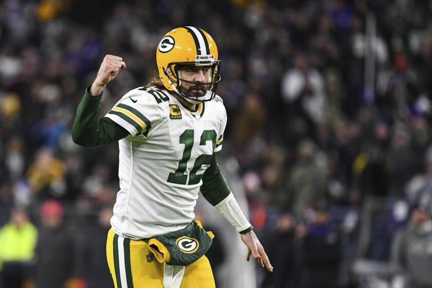 Green Bay Packers quarterback Aaron Rodgers (12) reacts to throwing a fourth quarter touchdown.