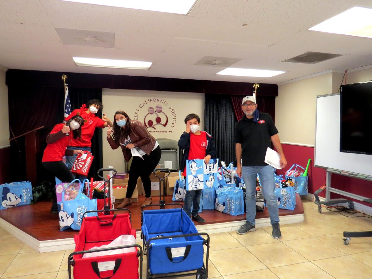 AccessCal volunteers and fellow community members sort and distribute donated toys to underserved children for Christmas.