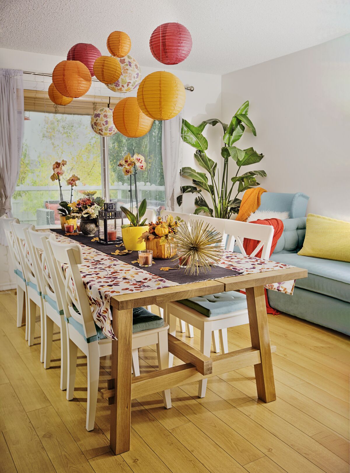A dining room with a large table and couch for relaxed seating.