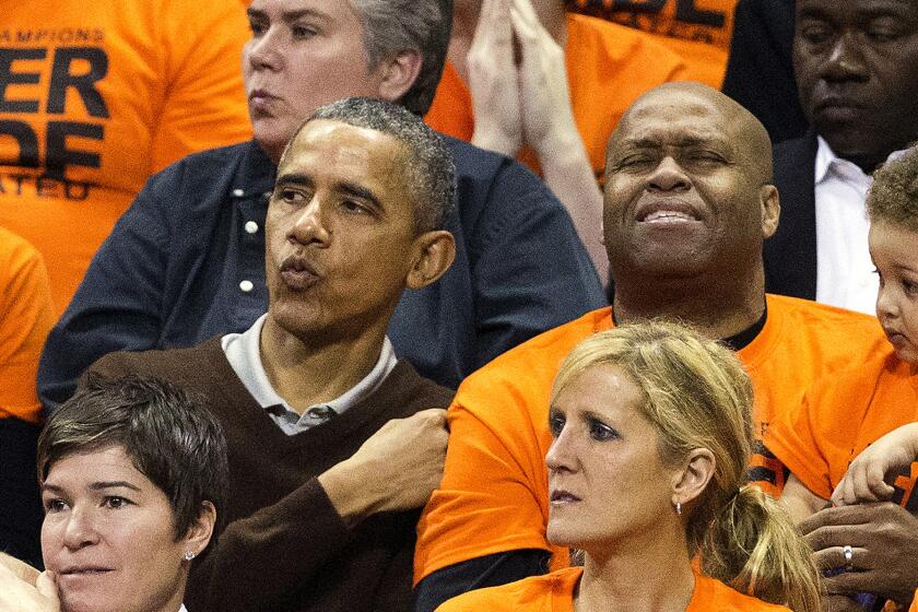 President Barack Obama and his brother-in-law, former Oregon State coach Craig Robinson react to Wisconsin Green Bay scoring against Princeton in the second half Saturday.