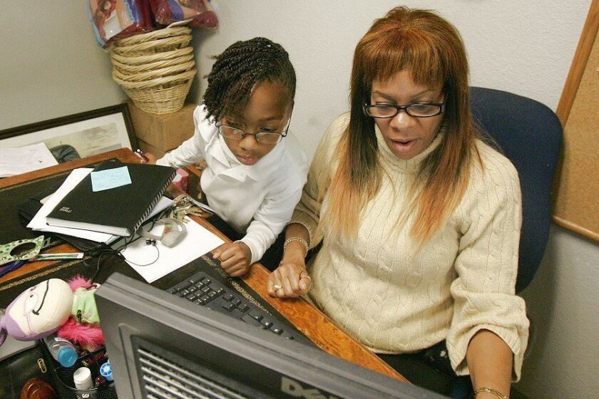 Dianne Yarborough at her desk in the San Diego Rescue Mission’s Women and Children Center with her granddaughter, Jazza-Rae Curne.