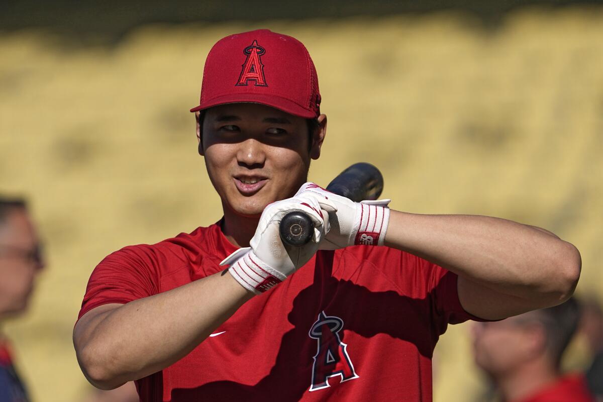 Angels star Shohei Ohtani smiles during batting practice against the Dodgers on Friday.