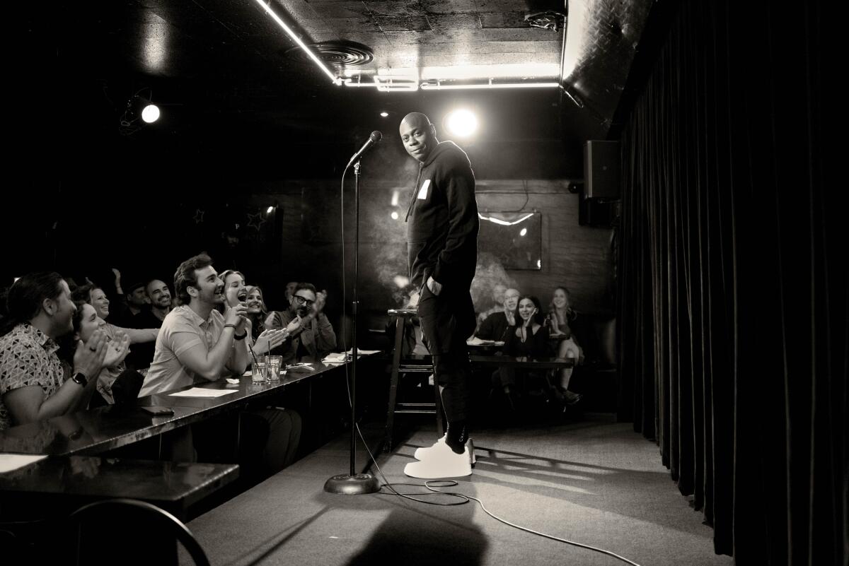 Dave Chappelle performing before a live audience.