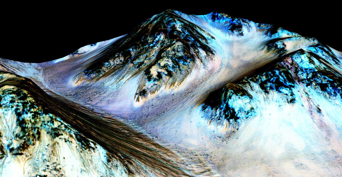 In this handout provided by NASA's Mars Reconnaissance Orbiter, dark, narrow streaks on the slopes of Hale Crater are inferred to be formed by seasonal flow of water on surface of present-day Mars. These dark features on the slopes are called "recurring slope lineae" or RSL. Scientists reported on September 28, 2015 using observations with the Compact Reconnaissance Imaging Spectrometer on the same orbiter detected hydrated salts on these slopes at Hale Crater, corroborating the hypothesis that the streaks are formed by briny liquid water.