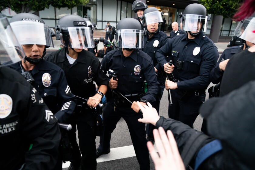 Police push forward moving protesters in the Fairfax District on May 30, 2020.