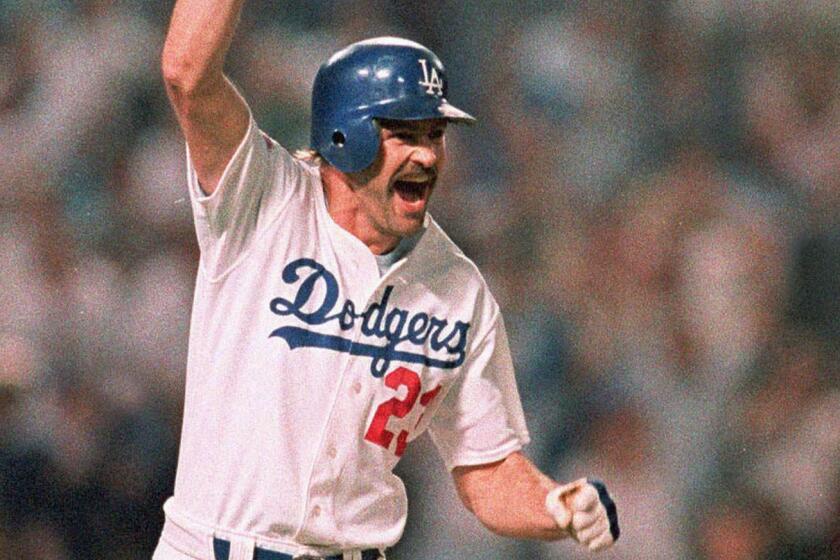 ** FILE ** Los Angeles Dodgers Kirk Gibson raises his arm in celebration as he rounds the bases after hitting a game-winning two-run home run in the bottom of the ninth inning to beat the Oakland Athletics 5-4 in the first game of the World Series at Dodger Stadium Oct. 15, 1988. The Detroit Tigers added Gibson to manager Alan Trammell's staff on Tuesday, Oct. 15, 2002. Gibson, who won World Series rings with the Tigers and the Dodgers, will be Detroit's bench coach after signing a three-year deal withthe team. (AP Photo/Rusty Kennedy)