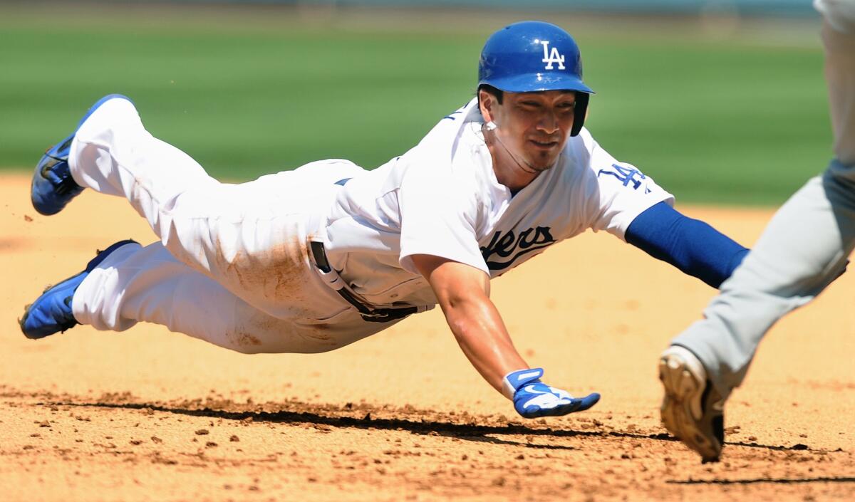 Darwin Barney dives back to first base but is doubled up by the Nationals in the sixth inning Wednesday at Dodger Stadium.