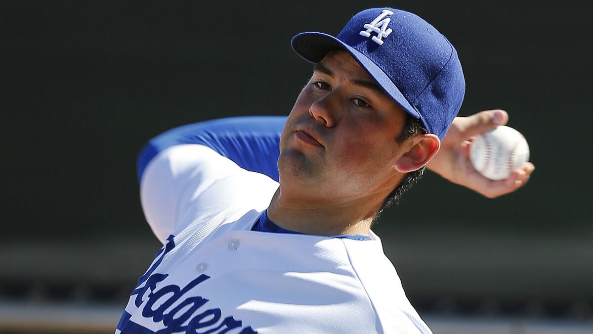 Dodgers pitcher Zach Lee throws during a spring training practice session in Phoenix on Feb. 20, 2014.