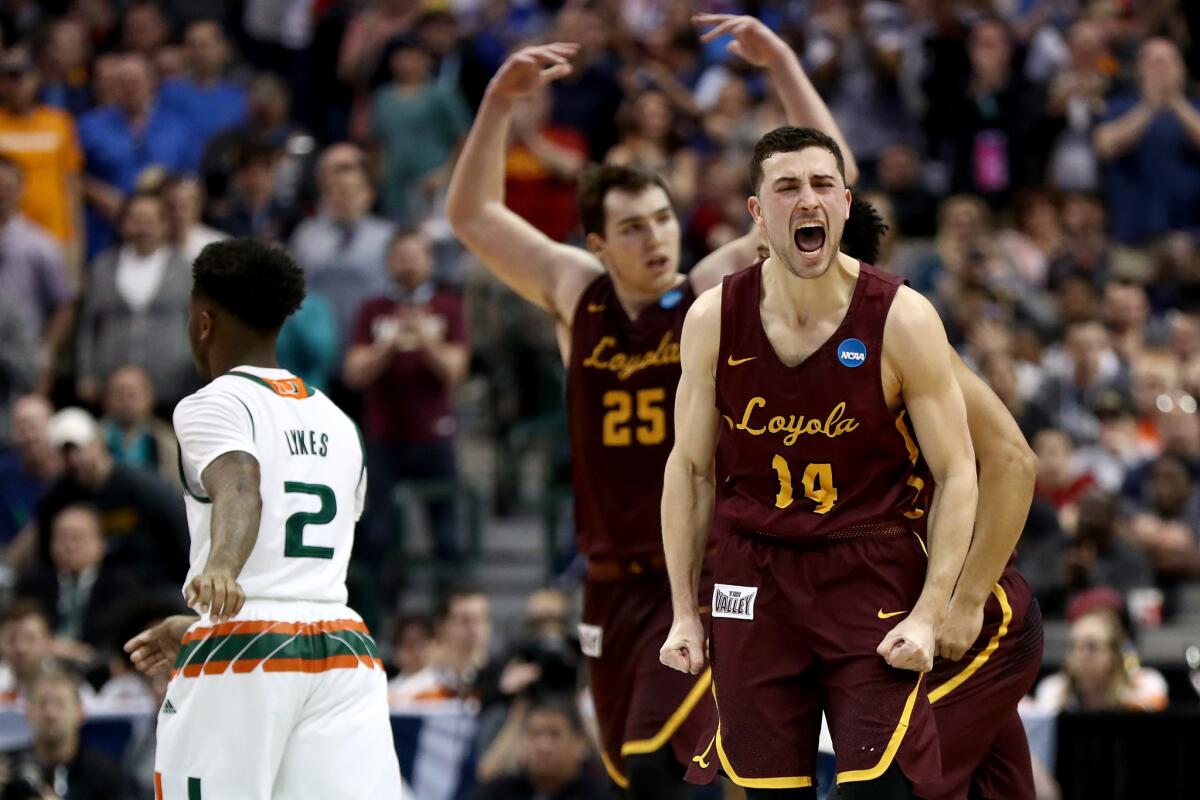 Loyola-Chicago's Ben Richardson (14) reacts after making a three-pointer in the second half against Miami in the NCAA tournament.