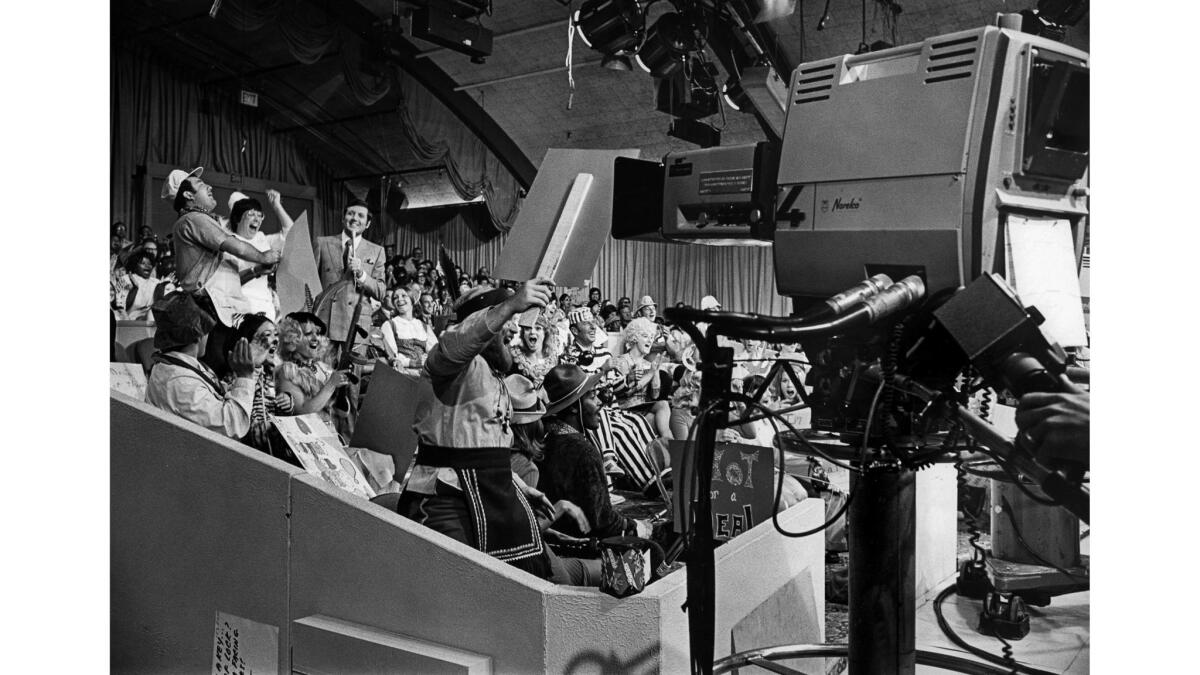 Aug. 1, 1973: Taping of the television show "Let's Make a Deal." Monte Hall is standing on left side of image next to two contestants dressed as painters.