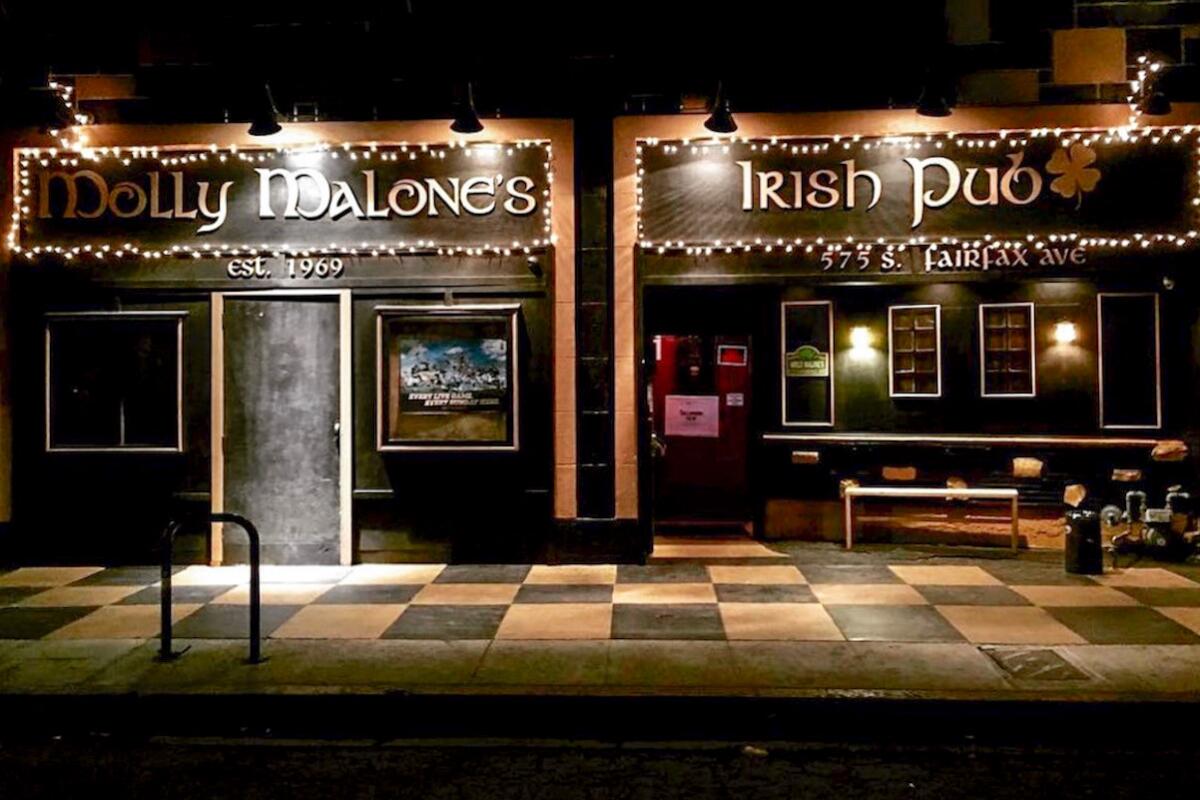 The exterior of Molly Malone's Irish Pub at night.