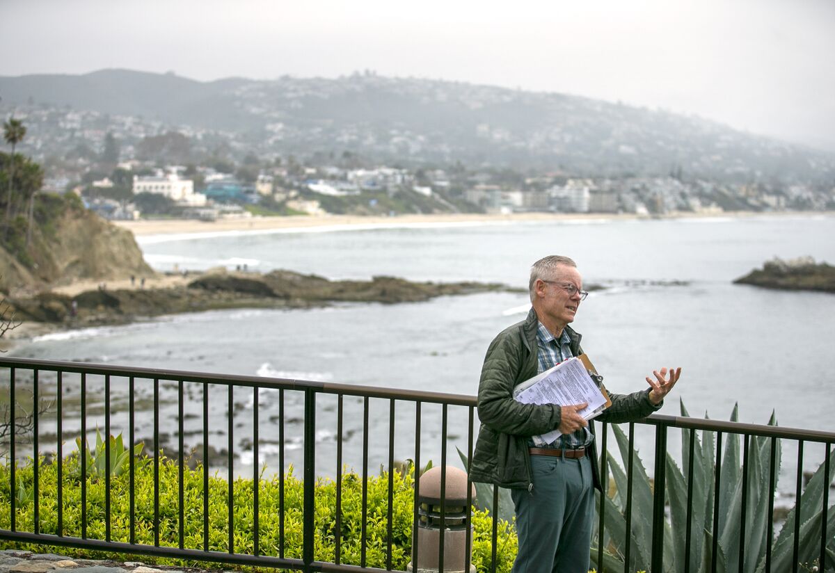 Bill Hoffman talks about the history of Laguna Beach and Dana Point during an abridged tour in Heisler Park on Tuesday.